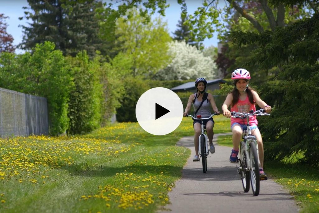 Mother and daughter biking together