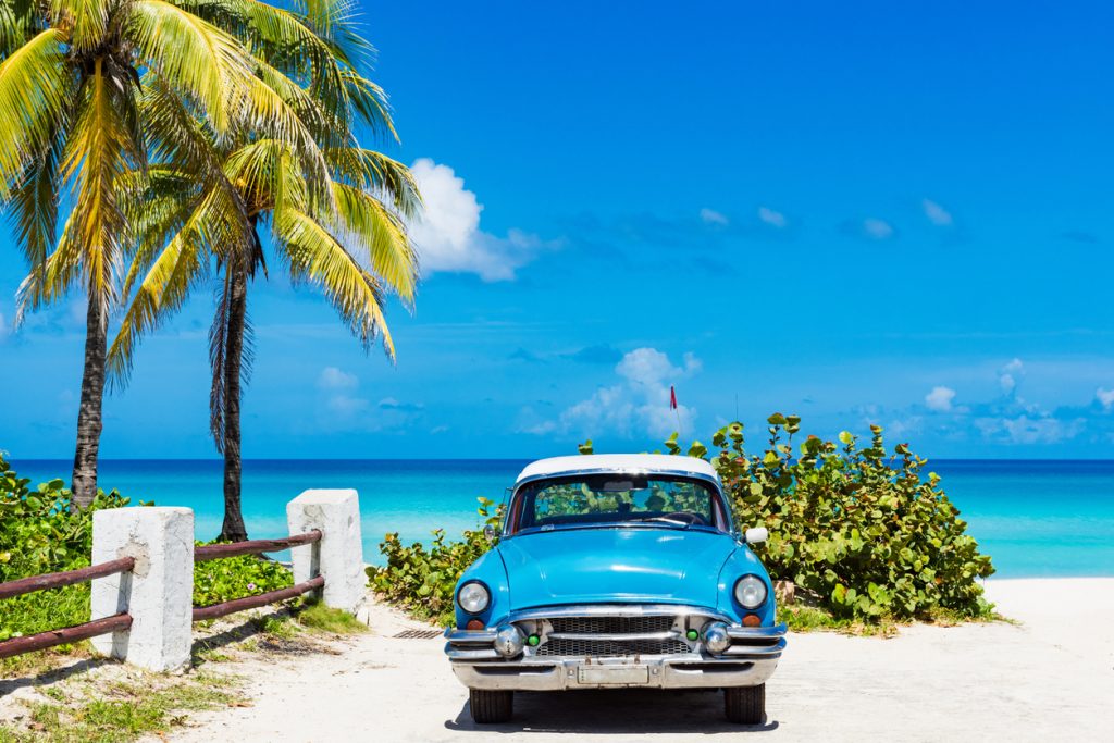 blue classic car on the beach