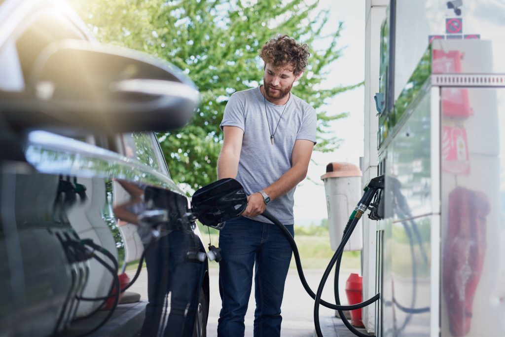 A man fills his vehicle with fuel at a fuel pumo