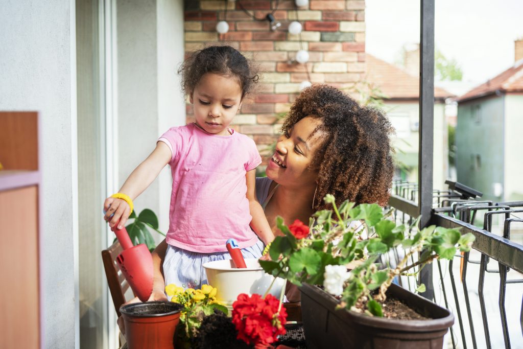 Mother and young daughter planting in thier small space garden