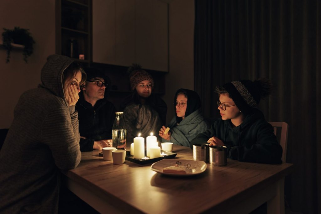 family sitting together in the dark