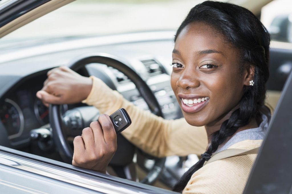 Woman driving car holding keys