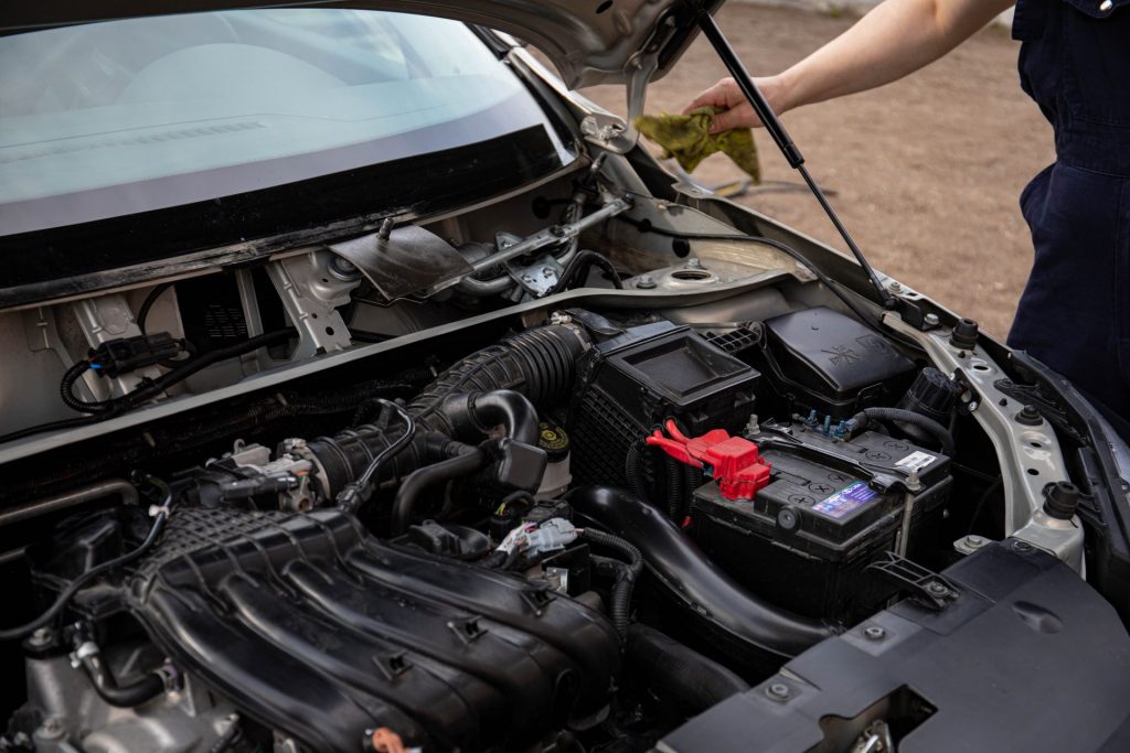 Looking inside the hood of a car at thecar battery