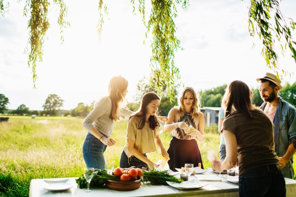 A group of friends perpare the table to eat local foods