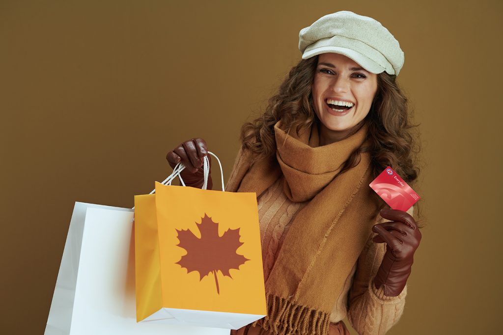 Woman holding CAA Everyday card