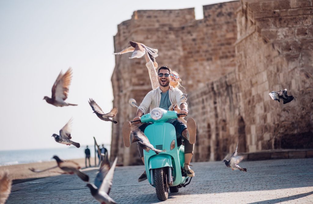 couple driving a scooter