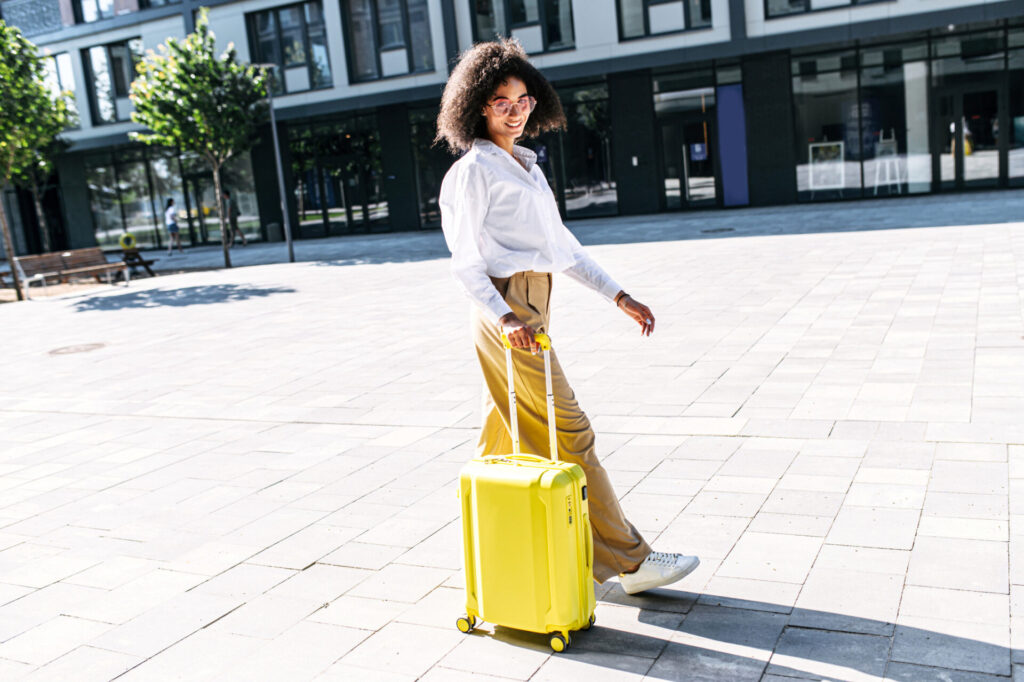 A woman with a suitcase outdoors