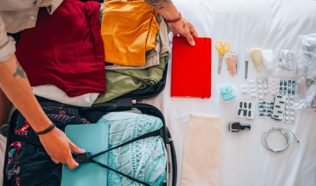 Directly above the man's hands packing for the trip