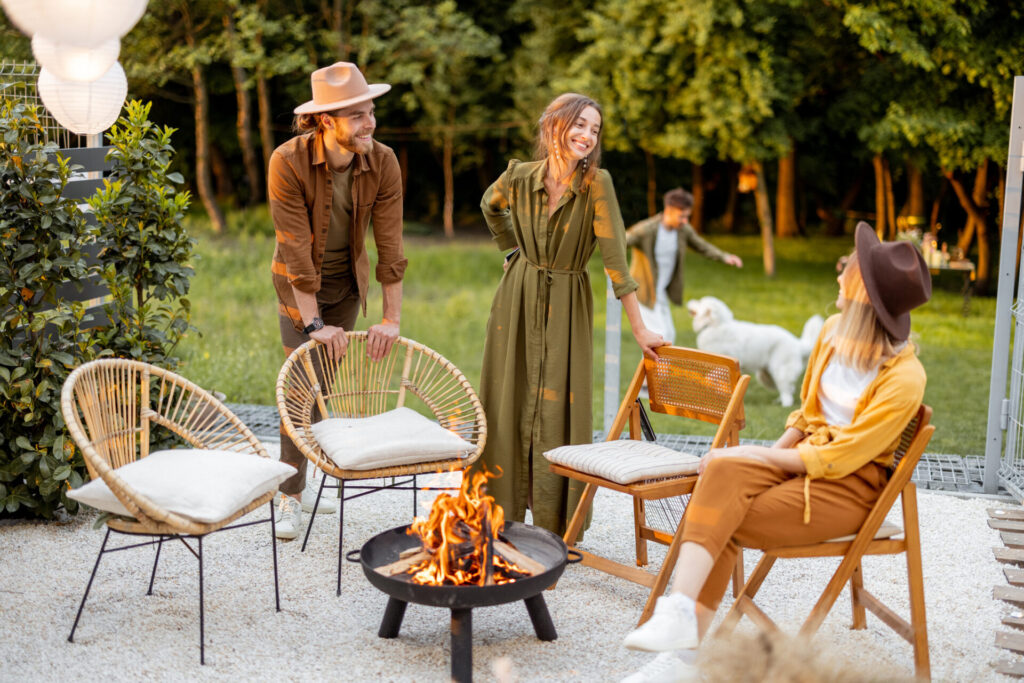 Friends sitting by a outdoor fireplace