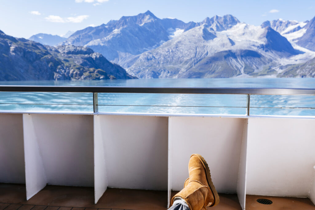 A passenger relaxes at the stern of a cruise ship in Glacier Bay National Park