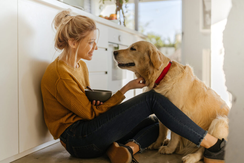 woman with dog in kitchen