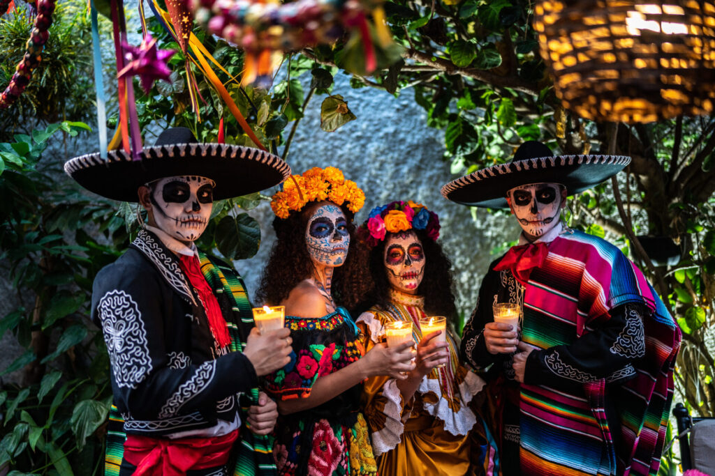 Portrait of a friends celebrating the day of the dead lighting candle