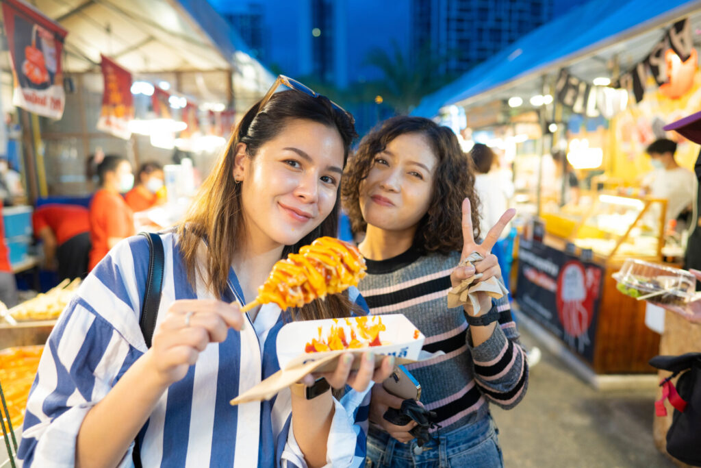 women enjoying in street food.