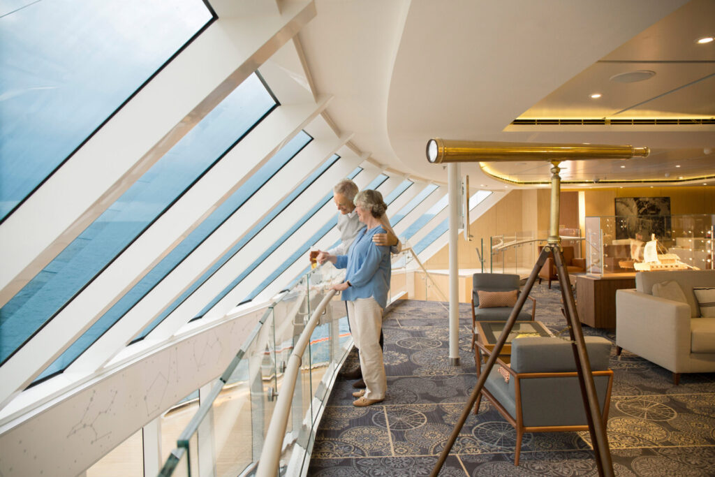 Couple looking out windows of the Explorer's Lounge