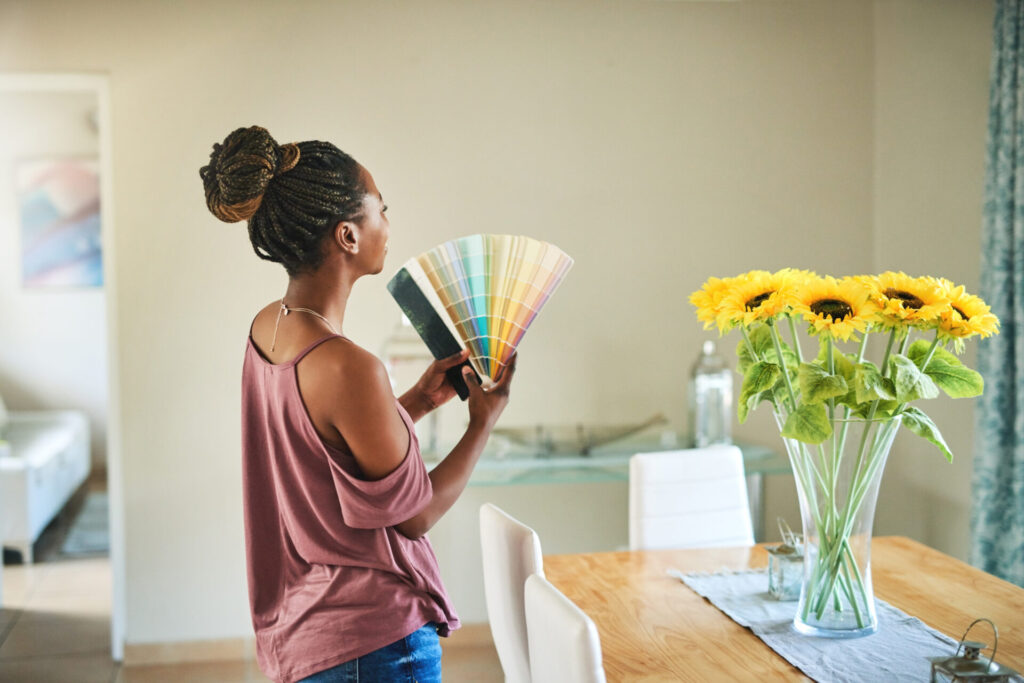 woman holding paint swatches