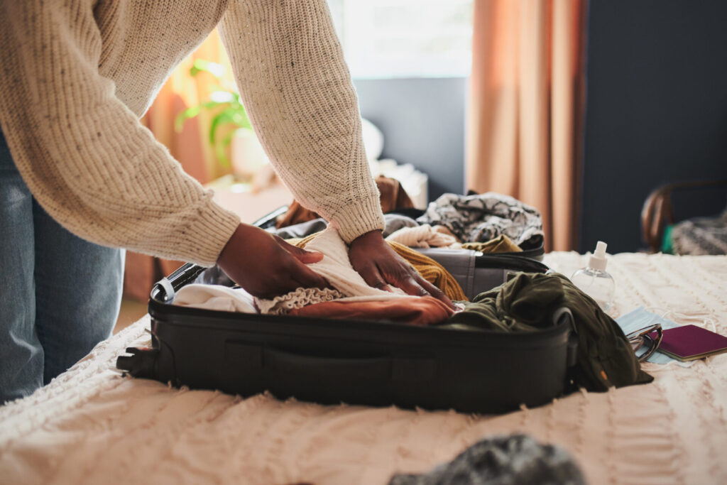 person packing suitcase