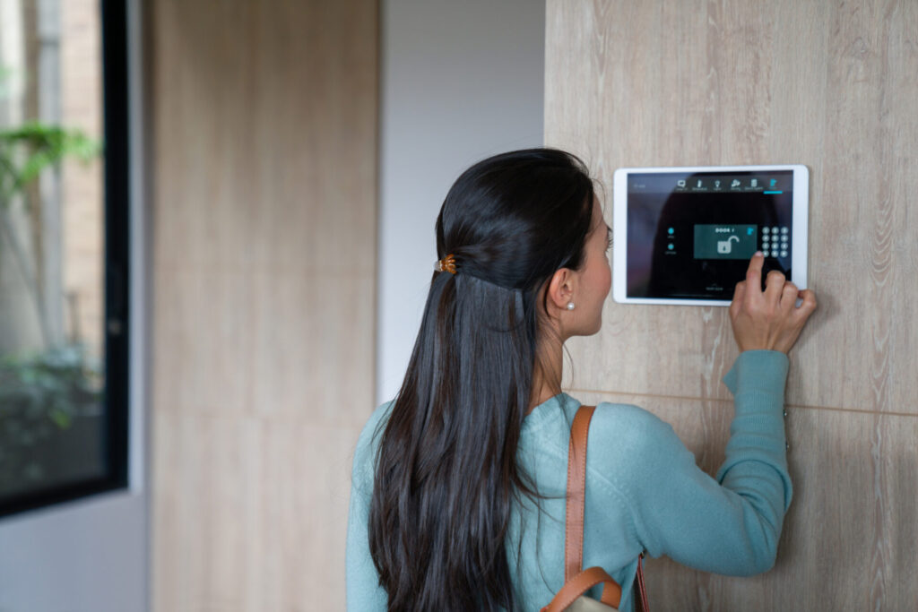 Woman entering pin to lock the door