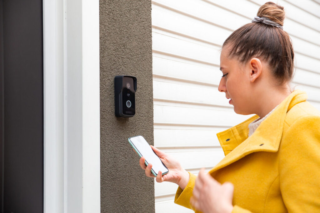 Woman using a phone to enter home