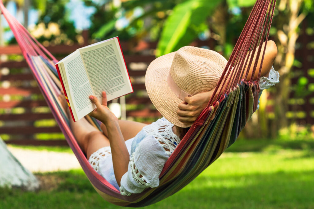 Woman reading book in hammock