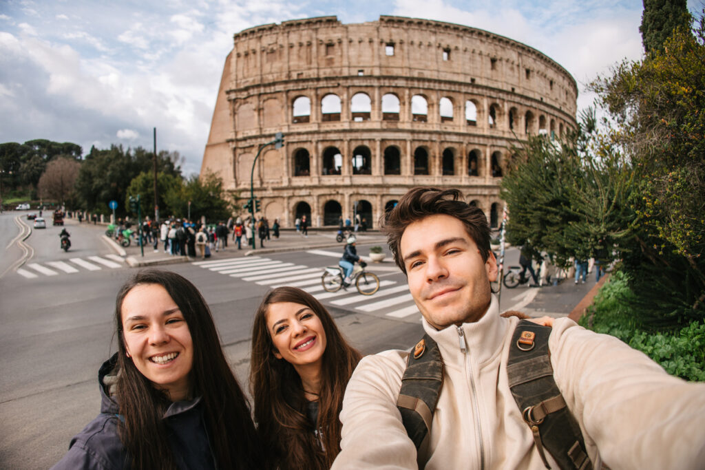 Tourists taking selfies in front of the Colosseum