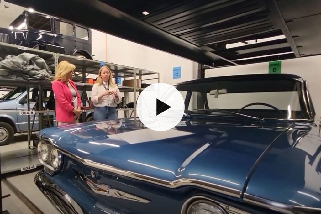 women talking next to a car