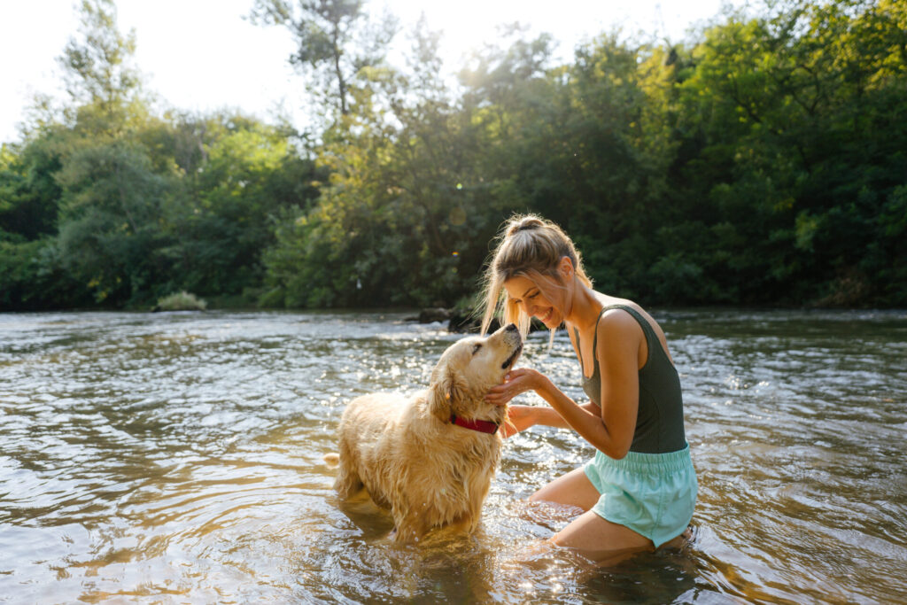 women swimming with dog