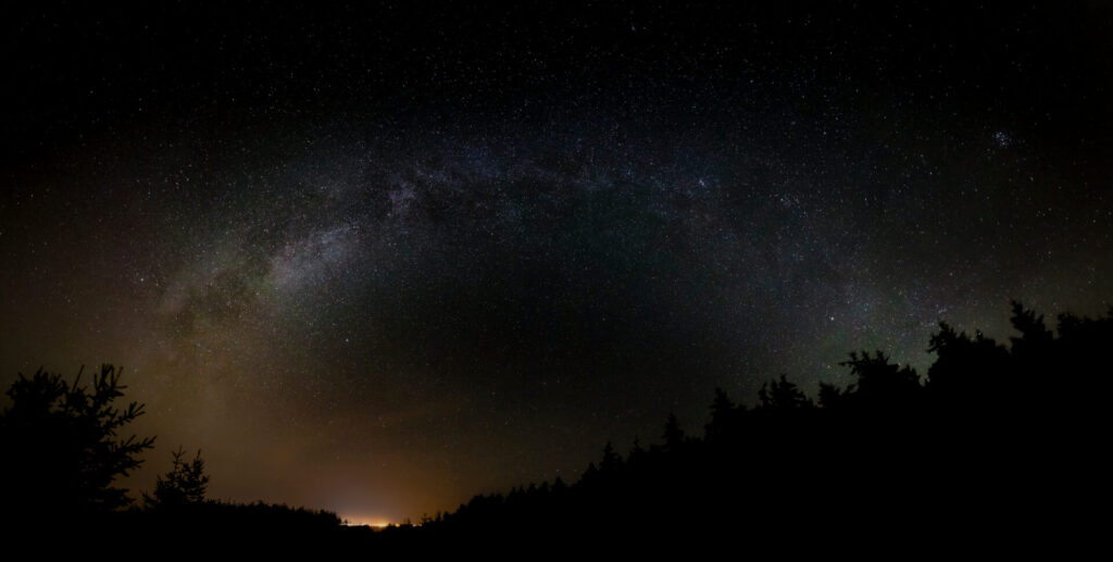 Atronomical panoramic view of the Milky Way Galaxy filled with stars in a night sky at the Prince Edward Island National Park, Canada